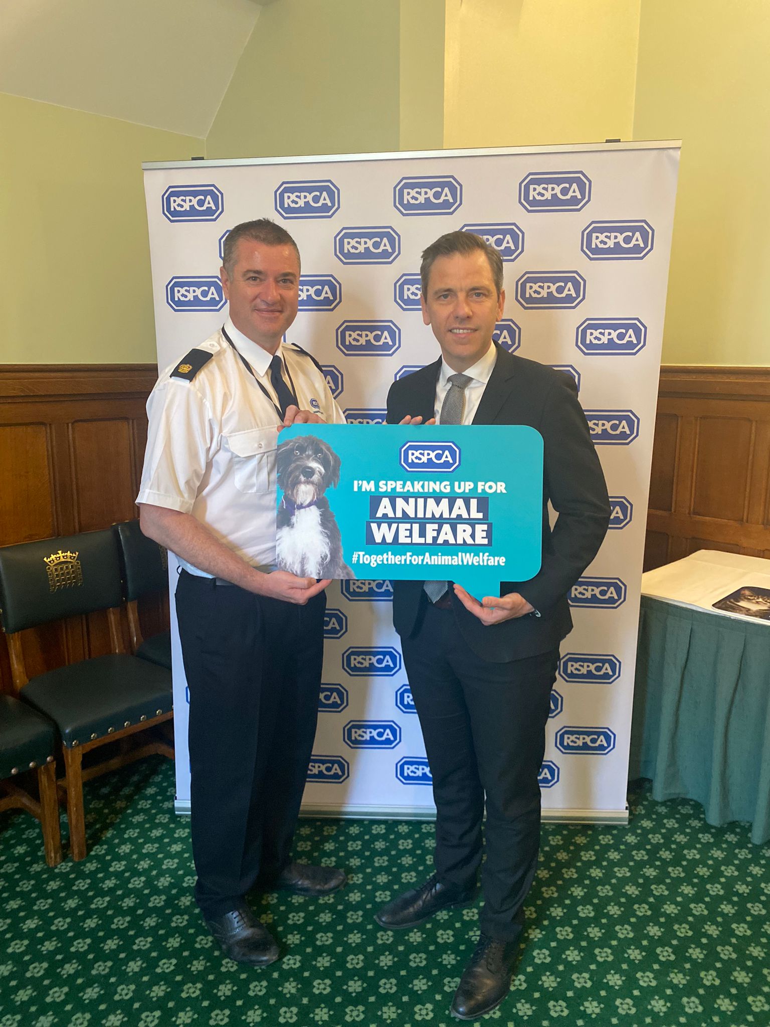 Chris Evans MP holds a sign that reads: I'm speaking up for Animal Welfare #TogetherForAnimalWelfare