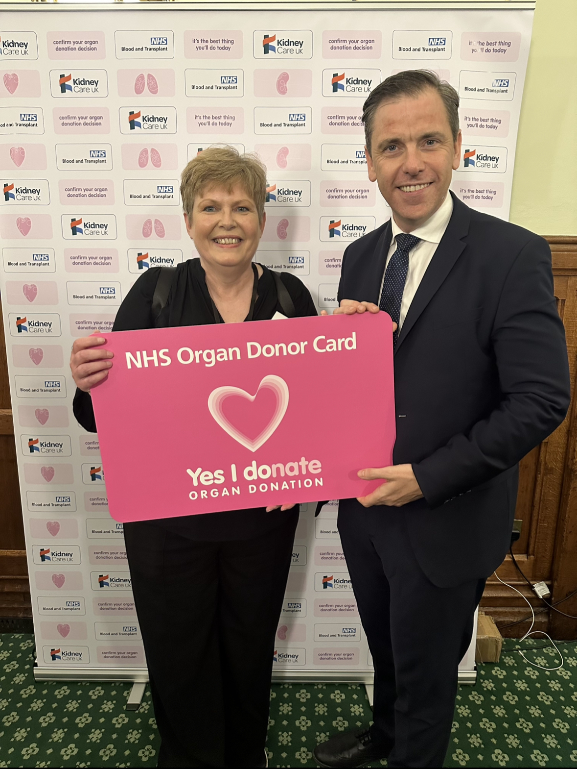Chris Evans MP stands with a constituent holding a sign that reads: NHS Organ Donor Card